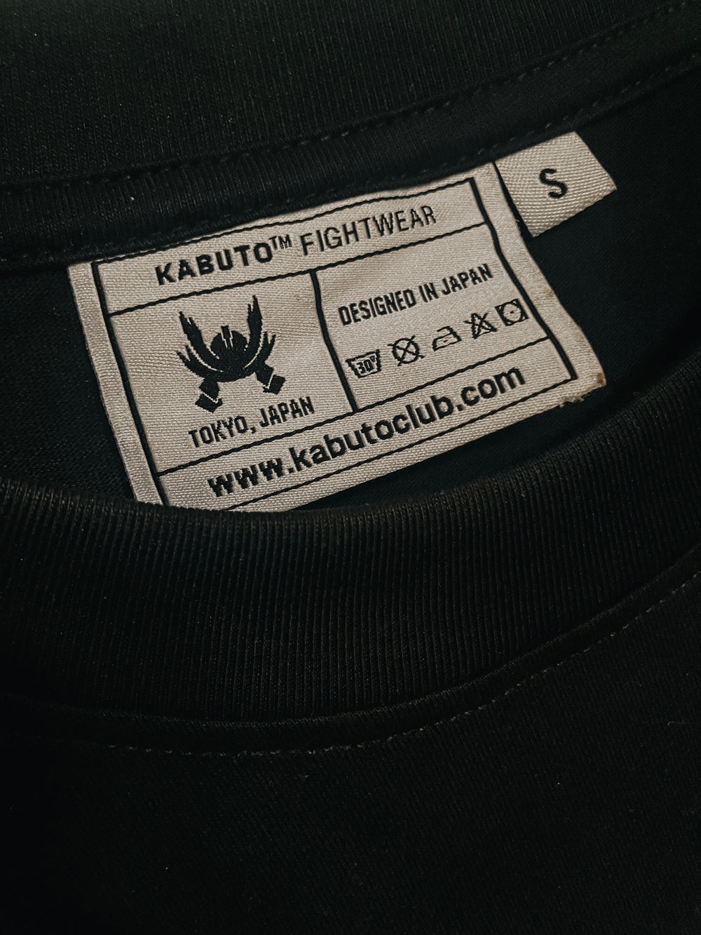 Close-up of the Kabuto garment label reading Designed in Japan